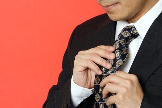 Businessman tying up his tie