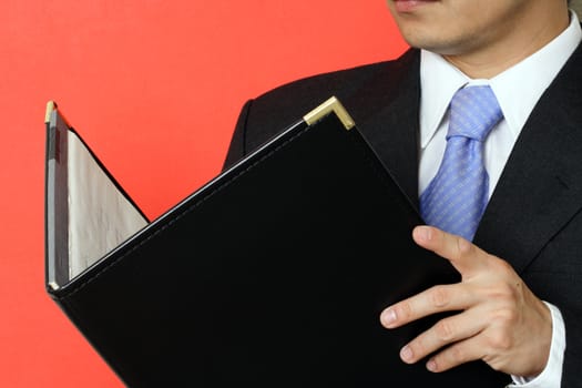 Businessman reading his notepad