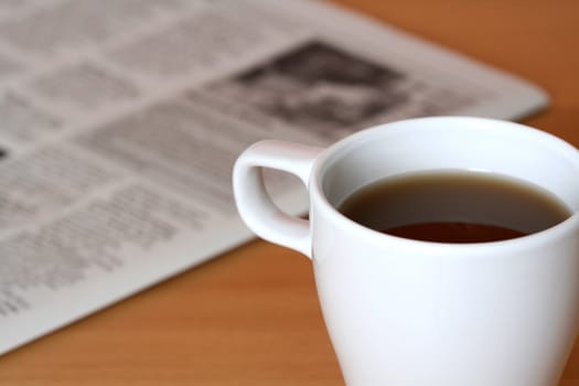 A cup of coffee and a newspaper