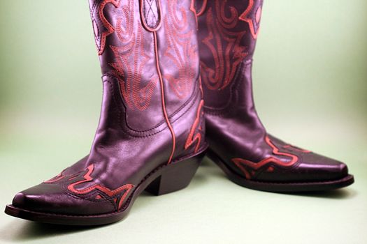 A pair of black and orange western cowboy boots.
