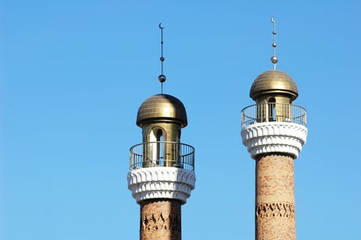 Landmarks of historical mosque towers with blue sky as background