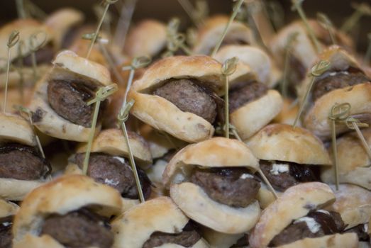 Mini burgers served as appetizers at a party