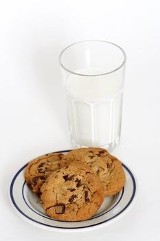 Three chocolate chips cookies and a glass of milk