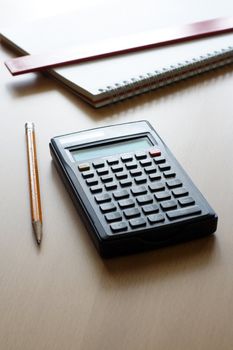 A calculator and a pencil, business/finance concept