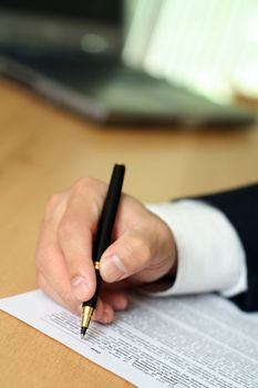 Businessman filing out a form