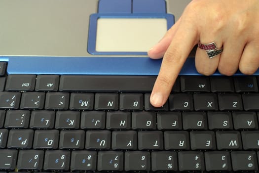 Business woman typing on a laptop