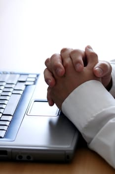 Businessman thinking while working on a laptop