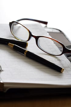 An organizer and a pair of glasses