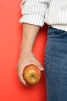 A man holding an apple, can be used for health concept