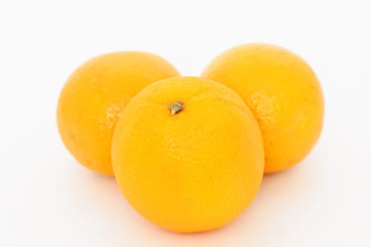 Three oranges over white background