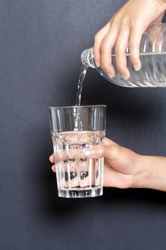 Pouring water into a glass