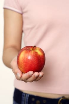 A woman holding an apple