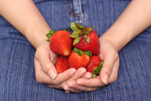 A woman holding strawberries