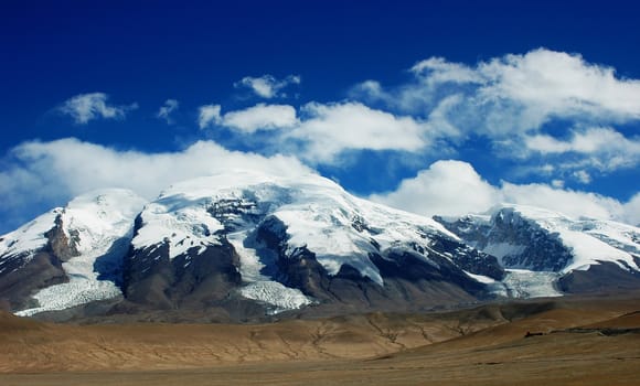 Landscape of snow mountains with blue sky and white clouds