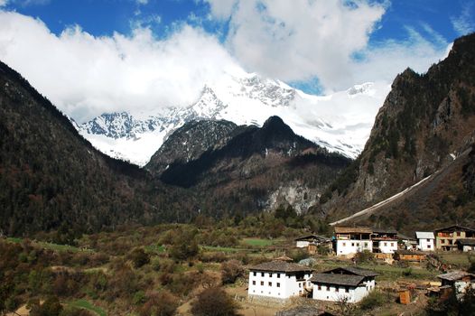 Landscape of snow mountains and village in Shangrila China