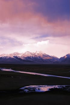 Landscape of snow mountains and stream in Tibet