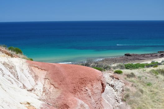 Beautiful azure, blue water beach with red stone. Hallett Cove Conservation Park, South Australia.