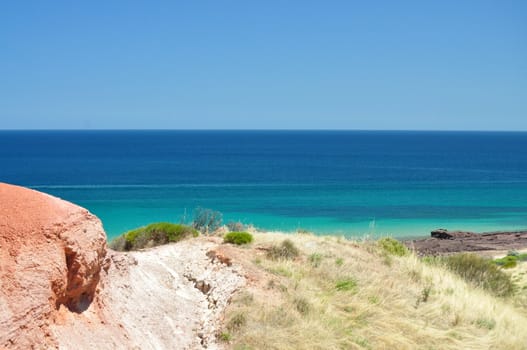 Beautiful azure, blue water beach with red stone. Hallett Cove Conservation Park, South Australia.