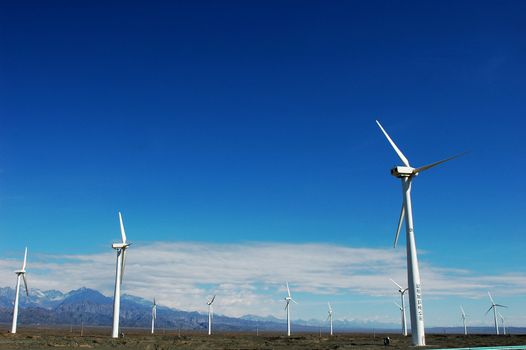 Wind turbine generators in sinkiang,china,with blue skies and white clouds as backgrounds