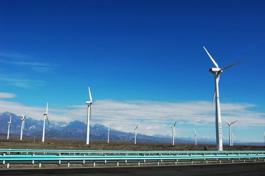Wind turbine generators in sinkiang,china,with blue skies and white clouds as backgrounds