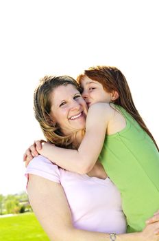 Portrait of happy child hugging and kissing her mother
