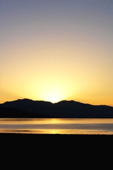 Landscape of mountains and lake at sunrise