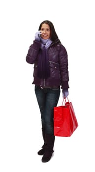 Young woman with shopping bags using a mobile phone.

