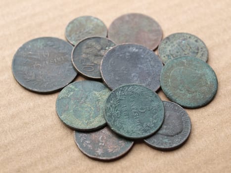 A heap of many ancient rusted coins