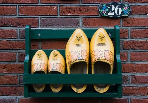 Storage rack with wooden shoes next to Dutch frontdoor