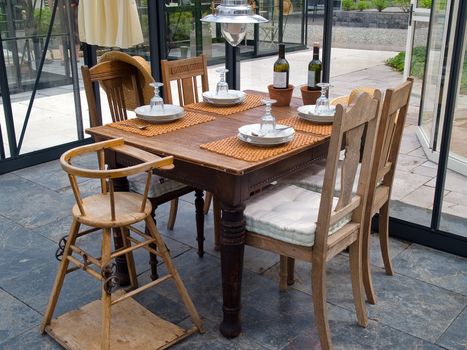Cozy rustic style conservatory sun room solarium with tables and chairs 