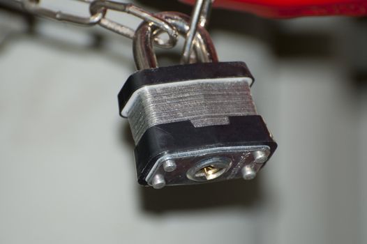 a close-up shot of a heavy duty padlocklocking a chain