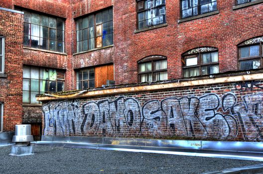 a wall covered with graffiti on an odl abandoned building