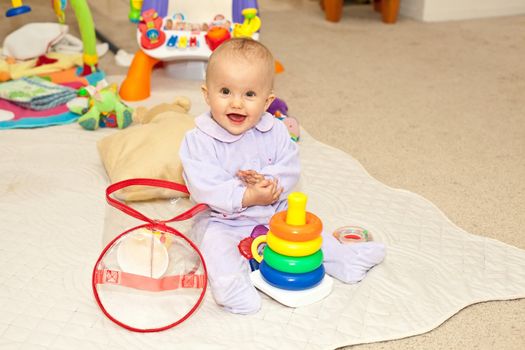 Caucasian baby girl playing on a floor.