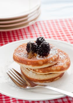 Delicious breakfast with pancakes, blackberries and honey