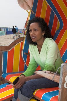 Beautiful woman sitting in a beachchair