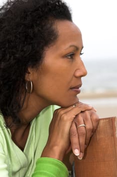 Beautiful black woman looking out over sea