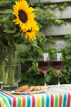 Table decked out for two with sunflowers on the table (focus on sunflowers)