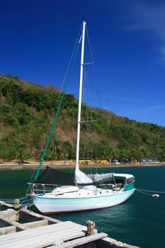 sail boat docked at a pier of a resort
