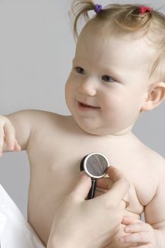 little girl examined by the doctor