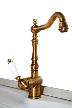 The copper faucet on a white background