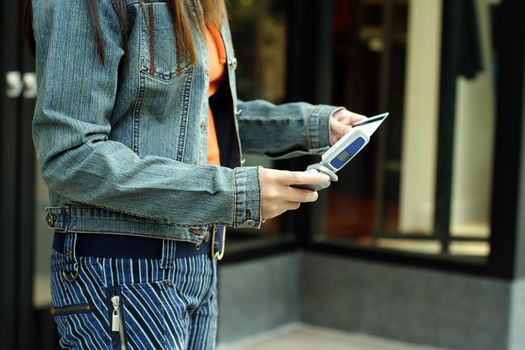 A woman calling credit card company while shopping