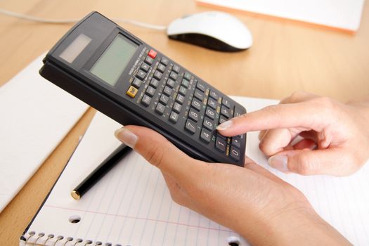 A woman uses a calculator