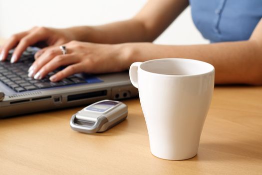 A businesswoman typing on a laptop