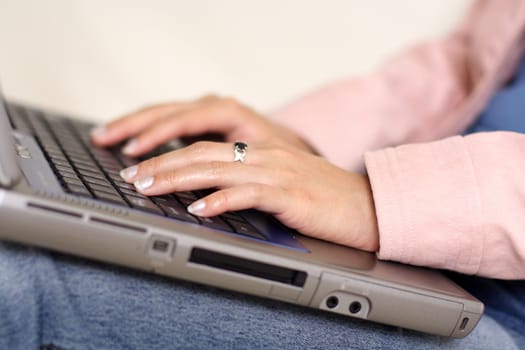 A woman typing on a laptop