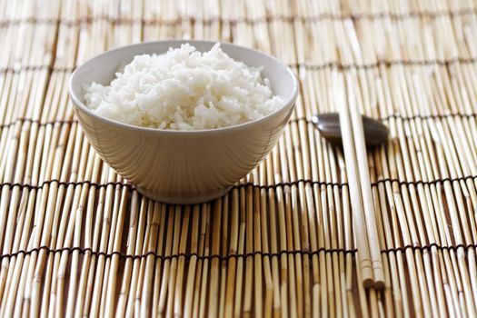 A bowl of rice and chopsticks