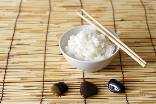 A bowl of rice and stones in zen environment