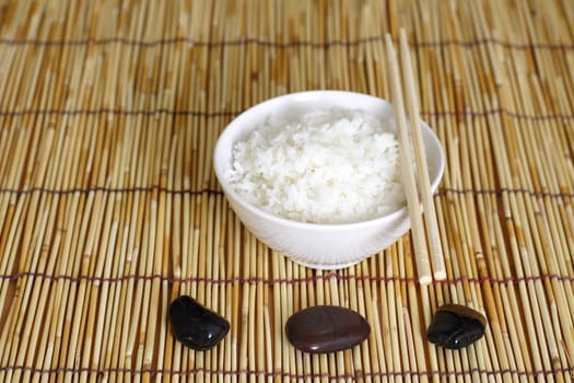 A bowl of rice and stones in zen environment