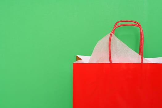 Red shopping bag on green background