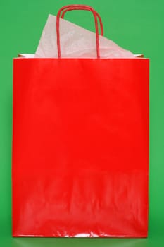 Red shopping bag on green background