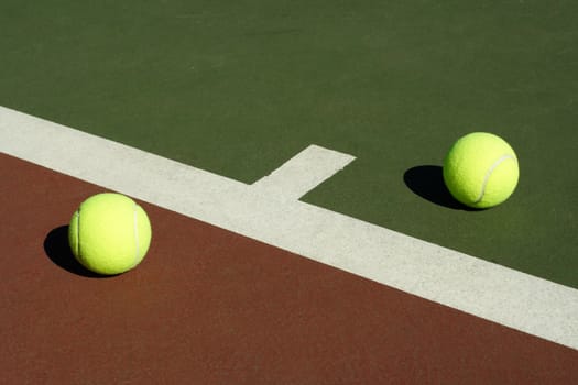 Two tennis balls in a tennis court